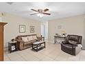 Comfortable living room with tile flooring, ceiling fan, and neutral decor, creating a welcoming and relaxing space at 1503 Canterbury Cir, Casselberry, FL 32707