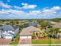 Beautiful home with a three-car garage in a community featuring a tranquil lake and fountain at 16313 Birchwood Way, Orlando, FL 32828
