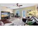 Inviting living room features hardwood floors, neutral green paint, and access to the patio at 171 Mcleods Way, Winter Springs, FL 32708