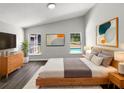 Bright bedroom features a modern style, high ceilings, contemporary decor, and windows offering a view of the pool at 17505 Silver Creek Ct, Clermont, FL 34714