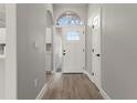 Bright foyer features hardwood floors, arched window, and a modern white door at 1862 Spreakley Ct, Orlando, FL 32837