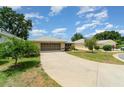 Charming single-story home boasts a well-manicured lawn and an inviting screened two-car garage at 21529 Prince Albert Ct, Leesburg, FL 34748