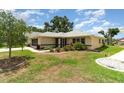 Well maintained lawn with shrubbery and mulch around the home's foundation at 21529 Prince Albert Ct, Leesburg, FL 34748