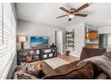Open living area with tile floors, ceiling fan and access to the kitchen at 2935 Arcata Ln, Orlando, FL 32817
