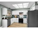 Modern kitchen with stainless steel appliances, white cabinets, and sleek countertop at 307 Coble Dr, Longwood, FL 32779