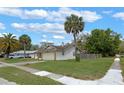 Single-story home featuring a one-car garage, driveway, and a well-maintained front lawn with palm trees at 3199 Tobago Ct, Apopka, FL 32703