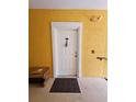Condo entrance featuring a secure front door, welcome mat, and exterior lighting at 3577 Conroy Rd # 331, Orlando, FL 32839