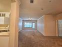 Spacious living room featuring plush carpeting, neutral walls, and natural light from the large window at 3577 Conroy Rd # 331, Orlando, FL 32839