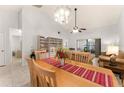 Open-concept dining area featuring a large table for six, flowing seamlessly into the living space with natural light at 4232 Sandhurst Dr, Orlando, FL 32817