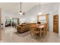 Bright living room with vaulted ceilings, tile flooring, and an adjacent sunroom perfect for relaxation and entertaining at 4232 Sandhurst Dr, Orlando, FL 32817