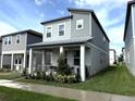Charming two-story home with a covered porch and manicured landscaping at 4828 Abbeywood Aly, Winter Garden, FL 34787