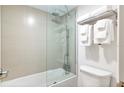 Modern bathroom featuring a shower-tub combo with sleek glass door and towel rack at 5245 W Irlo Bronson Memorial Hwy # 170, Kissimmee, FL 34746
