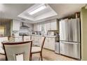 Bright eat-in kitchen featuring stainless steel appliances, white cabinets and tile backsplash at 5501 Vance Ave, Orlando, FL 32810