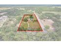 Aerial view of property with outlined land, surrounded by lush greenery and neighboring homes at 6803 Round Lake Rd, Mount Dora, FL 32757