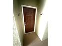Brown front door with white trim and a door knocker labeled with the unit number 915 at 814 Crest Pines Dr # 915, Orlando, FL 32828