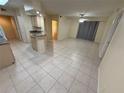 Open floor plan with tile flooring, connecting the living room and kitchen areas at 814 Crest Pines Dr # 915, Orlando, FL 32828