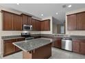 Modern kitchen with granite countertops, stainless steel appliances, and ample cabinet space at 8554 Tallfield Ave, Orlando, FL 32832