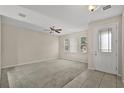 Spacious living room with neutral walls, ceiling fan, and tile entryway at 8554 Tallfield Ave, Orlando, FL 32832