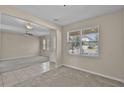 Inviting living room featuring neutral walls, carpet, and bright windows at 8554 Tallfield Ave, Orlando, FL 32832