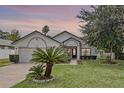 Lovely one-story house showcasing manicured lawn, a two-car garage, and a cozy front entrance path at 1003 Hart Branch Dr, Oviedo, FL 32765