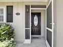 Close-up of the home's entry, showcasing a stylish front door with a screen door and house number at 1136 Villa Ln # 96, Apopka, FL 32712
