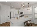 Stylish kitchen with white cabinets, quartz countertops, stainless steel appliances, and a breakfast bar at 1151 Wildmeadow Run, Winter Park, FL 32792