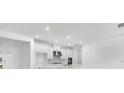 Bright kitchen features white cabinets, stainless steel appliances, a marble backsplash and a large countertop at 12869 Harvest Rain Ave, Winter Garden, FL 34787