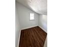 Finished attic room featuring sleek flooring, fresh paint, and a window allowing natural light to fill the space at 1310 Polk City Rd, Haines City, FL 33844