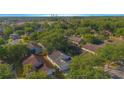 Overhead view of the home nestled amongst a community with mature landscaping and nearby power plant at 13216 Wild Duck Ct, Orlando, FL 32828