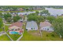 Expansive aerial view of a community with a large lake and homes with swimming pools at 13434 Mallard Cove Blvd, Orlando, FL 32837
