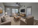 Bright and airy living room with a neutral color palette, ample seating, and modern decor at 136 Country Club Dr, Sanford, FL 32771