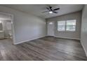 Spacious living room featuring vaulted ceilings, new luxury vinyl plank floors, and a ceiling fan at 136 Country Club Dr, Sanford, FL 32771