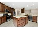 Spacious kitchen with stainless steel appliances, granite counters, and center island at 15366 Sandfield Loop, Winter Garden, FL 34787