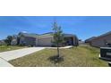 Beautiful exterior view of a single Gathering home with a well manicured lawn and two-car garage at 1540 Fleur Dr, Davenport, FL 33837