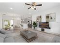 Living room with modern gray cabinets, kitchen island, contemporary decor, and a view to the backyard at 16927 Sw 25Th Terrace Rd, Ocala, FL 34473