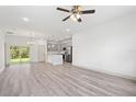 Open-concept living space with modern gray cabinets, a peninsula, and sliding glass doors at 16927 Sw 25Th Terrace Rd, Ocala, FL 34473