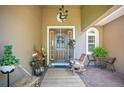 Inviting front porch with decor, seating, and a charming front door to welcome you home at 18108 Bellezza Dr, Orlando, FL 32820