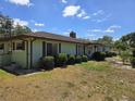Side view of a one-story home with verdant landscaping, showcasing its well-maintained exterior and clean design at 1872 N Akron Dr, Deltona, FL 32738