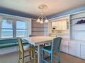 Charming dining room with ocean views, built-in cabinets, and seating for four at 1926 Ocean Shore Blvd # 3120, Ormond Beach, FL 32176