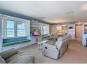 Bright living room features built-in shelves, window seating with ocean views, and comfortable furniture at 1926 Ocean Shore Blvd # 3120, Ormond Beach, FL 32176