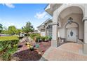 Front entrance showcasing a covered porch and manicured landscaping at 1994 Excalibur Dr, Orlando, FL 32822