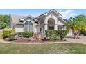 Landscaped front yard view with various decorations and bushes at 1994 Excalibur Dr, Orlando, FL 32822