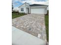 Paver driveway leading to a modern home with a two-car garage at 2013 Stone Wall Ct, Lake Hamilton, FL 33851