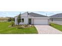Inviting single-Gathering home featuring a two-car garage, well-manicured lawn, and stylish modern design at 2013 Stone Wall Ct, Lake Hamilton, FL 33851