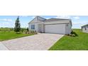 Beautiful single-Gathering home with a two-car garage, brick paver driveway, and well-maintained front yard at 2013 Stone Wall Ct, Lake Hamilton, FL 33851