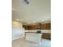 Bright kitchen features a center island, modern appliances, and plenty of cabinet storage at 2013 Stone Wall Ct, Lake Hamilton, FL 33851