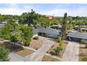 An elevated shot of the property showcases its landscaped front yard and mature shade trees at 2138 Whitehall Dr, Winter Park, FL 32792