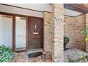 Close up of the front door with brick columns and a tiled entryway at 2138 Whitehall Dr, Winter Park, FL 32792