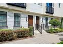 Close-up of townhome entrances with manicured shrubs, creating an inviting and well-maintained facade at 220 S Summerlin Ave, Orlando, FL 32801
