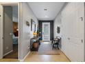 Stylish foyer with tile flooring, decorative mirror, and a view into the adjacent living spaces at 2614 Mead Ave, St Cloud, FL 34771